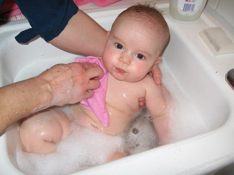 Bev (grandma) giving Lily a bath.jpg